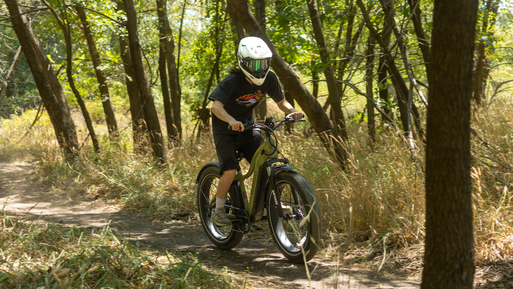 A person riding the GOTRAX Tundra electric bike with a 750 watt motor and torque sensor.