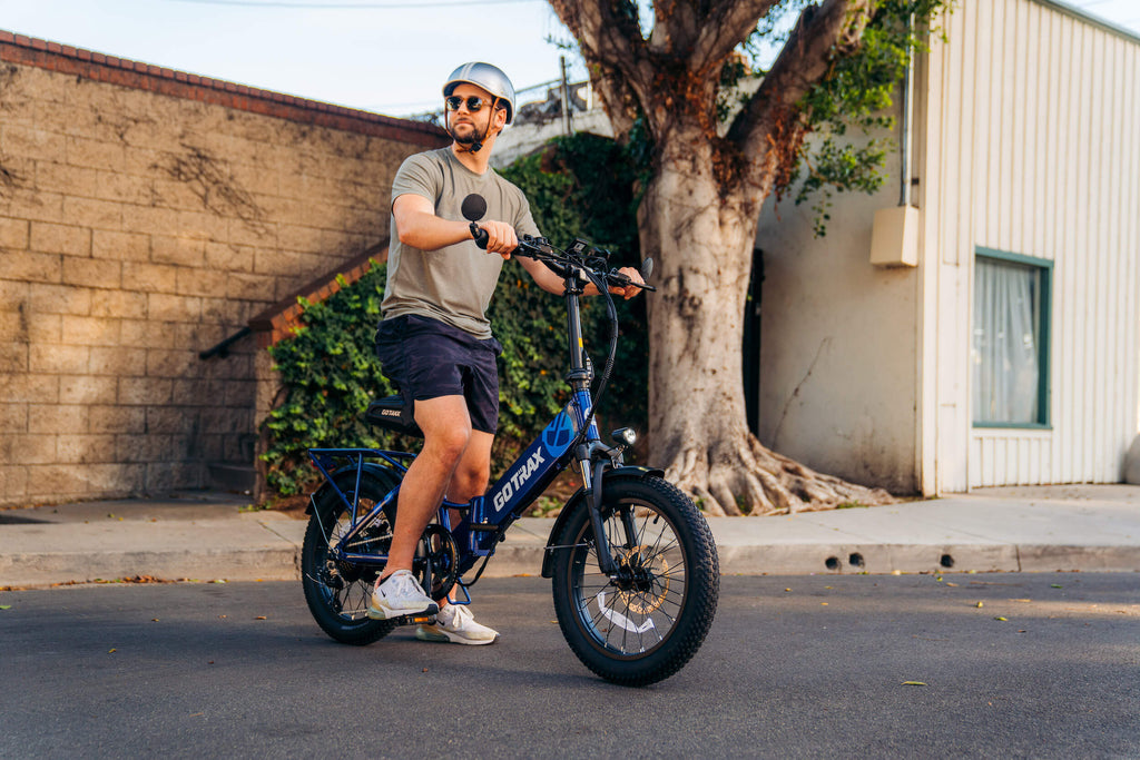 A man riding the GOTRAX F2V2 Foldable Electric Bike