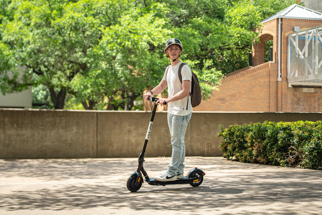 A man riding the GOTRAX Fusion Lightweight Electric Scooter