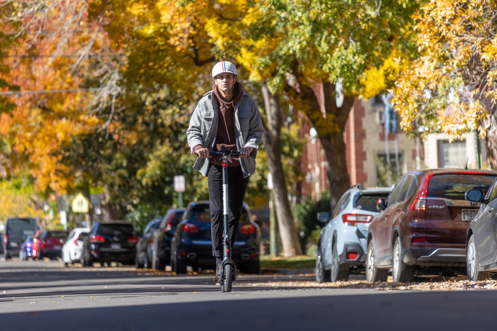 A man riding the GOTRAX G4 Electric Scooter for Adults.
