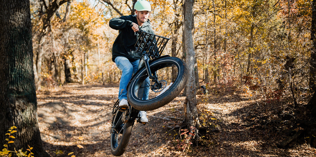 A man doing a jump on the GOTRAX Tundra Fat Tire Electric Bike.